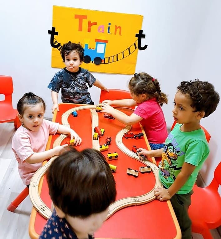Children playing together with train set